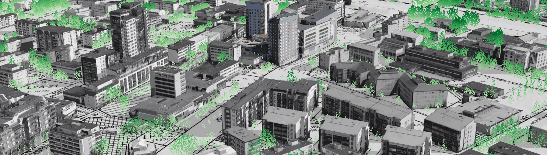 Kaupunkikuva, jossa on tiheästi rakennettuja kerrostaloja ja liiketiloja. Taustalla näkyy viheralueita ja puita.